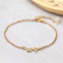 Orecchini e bracciali di tendenza con ciondoli e distanziatori con zirconia: